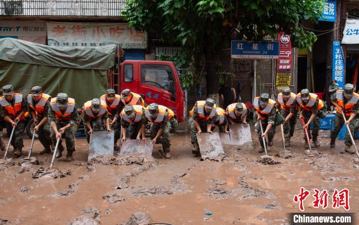 7月4日，萬州區(qū)五橋街道，武警官兵清理街道上的淤泥?！∪矫宪?攝