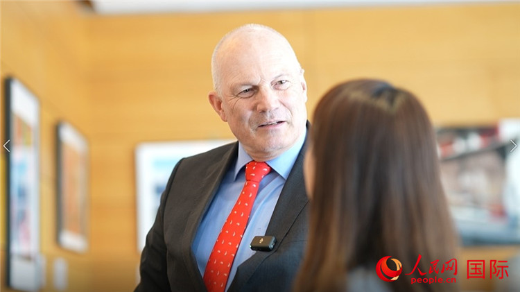 瑞士駐華大使白瑞誼介紹使館內陳列的照片。人民網(wǎng) 彭昱凱攝