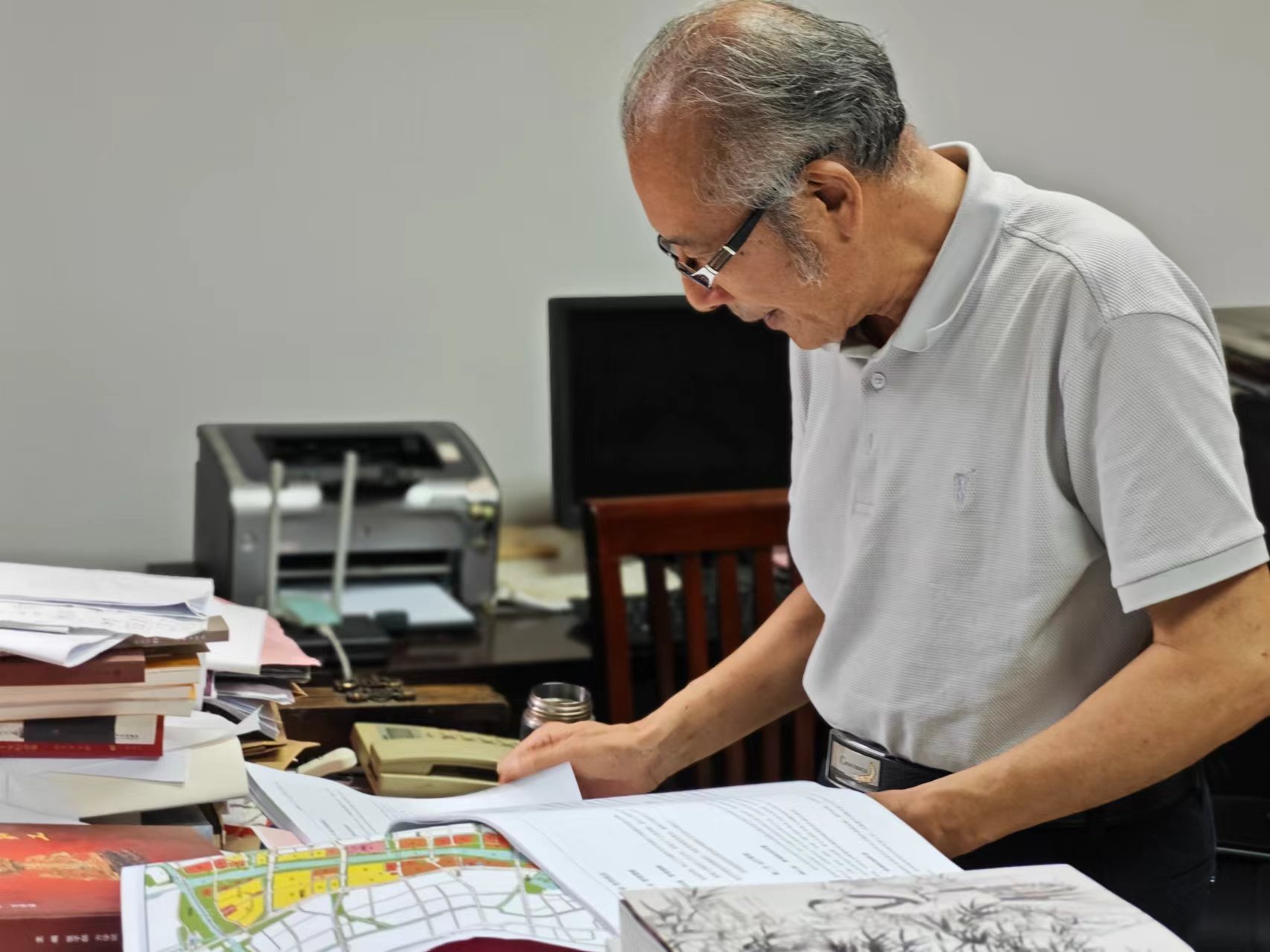 顧風在辦公室翻閱資料。人民網(wǎng)記者 黃鈺攝