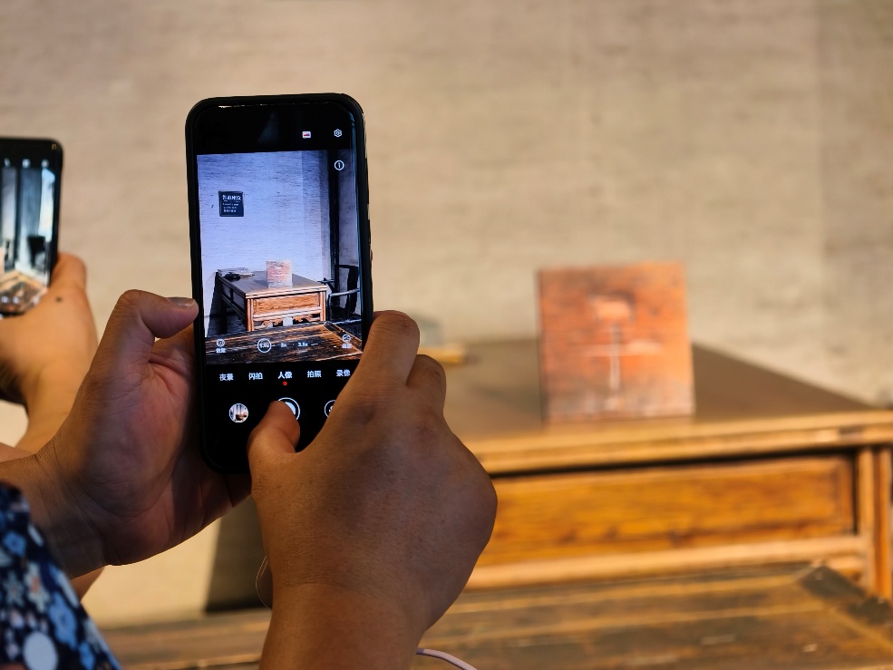 2025年7月15日，暑期研學(xué)團(tuán)小朋友在浙江省紹興市三味書屋拍攝魯迅讀書座位及課桌上的“早”字。受訪者供圖