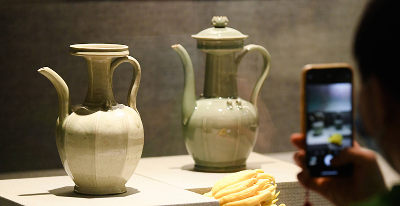 2021年9月14日，浙江省博物館，觀眾在拍攝北宋龍泉窯執(zhí)壺（左）和龍泉青瓷藝人劉杰制作的執(zhí)壺。