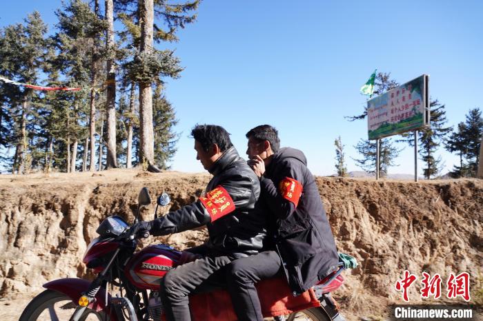 圖為同事騎摩托車載著桑杰加(后)前往林場(chǎng)?！●R銘言 攝