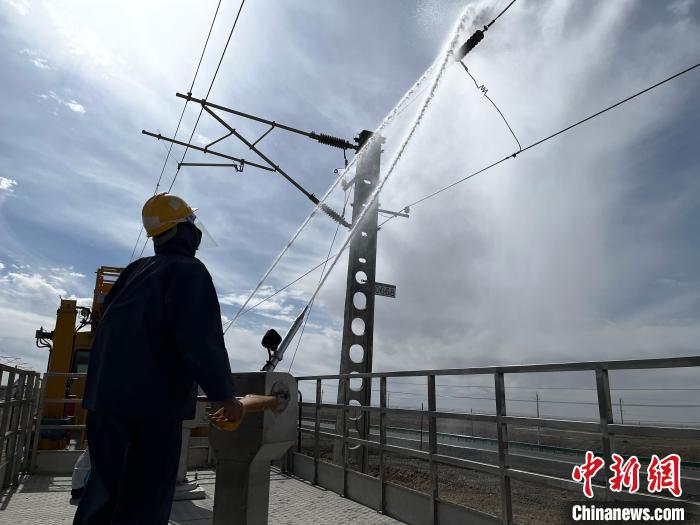圖為高壓水槍的水柱沖洗絕緣子串?！「邌⒑?攝