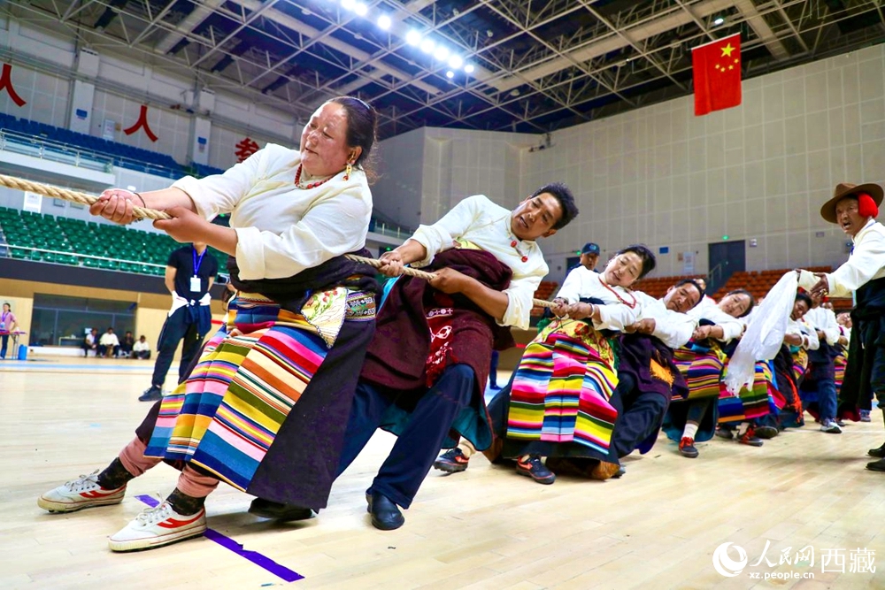 身著民族服裝的農(nóng)牧民選手在拔河比賽現(xiàn)場(chǎng)。
