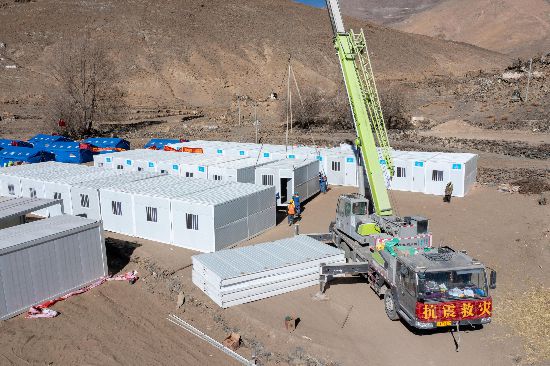 2025年1月9日，在定日縣長(zhǎng)所鄉(xiāng)古榮村安置點(diǎn)，救援人員和施工人員合力抓緊搭建移動(dòng)板房，確保受災(zāi)群眾溫暖過(guò)冬。人民網(wǎng)記者 翁奇羽攝